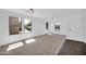Bright, open living room featuring neutral carpet, white walls, and three sunny windows at 25726 W Burgess Ln, Buckeye, AZ 85326