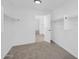 Walk-in closet with carpet, built-in shelving, and easy access to the bathroom at 25726 W Burgess Ln, Buckeye, AZ 85326