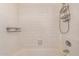 Full bathtub and shower with white tiled walls and chrome fixtures at 2625 E Indian School Rd # 143, Phoenix, AZ 85016