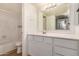 Bathroom with a vanity, white cabinets, and a tub with shower at 2625 E Indian School Rd # 143, Phoenix, AZ 85016