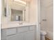 Bathroom vanity with large mirror, white cabinets, and a shower-tub combo at 2625 E Indian School Rd # 143, Phoenix, AZ 85016