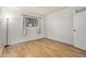 Sunlit bedroom featuring wood-look floors and a view of the outside at 2625 E Indian School Rd # 143, Phoenix, AZ 85016