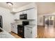 A modern kitchen includes white cabinets, stylish backsplash, and new appliances at 2625 E Indian School Rd # 143, Phoenix, AZ 85016