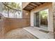 Private patio area with sliding glass door, neutral stucco, and gravel landscaping for low maintenance living at 2625 E Indian School Rd # 143, Phoenix, AZ 85016
