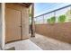 Cozy patio area featuring desert landscaping, stucco wall with metal railing, and a convenient storage closet at 2625 E Indian School Rd # 143, Phoenix, AZ 85016