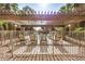 Lounge chairs under a wooden pergola by the pool offer a perfect spot for relaxation and soaking up the sun at 2625 E Indian School Rd # 143, Phoenix, AZ 85016