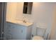 Practical bathroom with a toilet, sink, cabinet storage, and white fixtures at 303 S Recker Rd # 78, Mesa, AZ 85206
