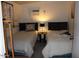 Comfortable bedroom featuring twin beds, a side table with lamp, and a window AC unit at 303 S Recker Rd # 78, Mesa, AZ 85206