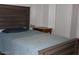 Cozy bedroom features a wood-look headboard and small wood nightstand at 303 S Recker Rd # 78, Mesa, AZ 85206