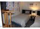Cozy bedroom featuring twin beds, a side table with lamp, and a window AC unit at 303 S Recker Rd # 78, Mesa, AZ 85206