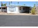 Well-maintained mobile home featuring an attached carport and light blue trim on the windows at 303 S Recker Rd # 78, Mesa, AZ 85206