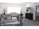 Spacious living room featuring a comfortable sofa, TV, and dining table at 303 S Recker Rd # 78, Mesa, AZ 85206
