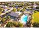 Aerial shot of a community pool, tennis courts, and neighborhood homes surrounded by mature trees at 3037 E Hobart St, Gilbert, AZ 85296