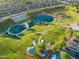 Aerial view of a large community park with ponds, playgrounds, and green spaces at 3037 E Hobart St, Gilbert, AZ 85296