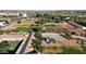 Aerial view of a school next to crops divided by rows with mountains on the horizon at 3037 E Hobart St, Gilbert, AZ 85296