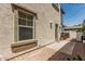 Exterior shot of a backyard with a brick patio and stucco wall. Includes a small seating area at 3037 E Hobart St, Gilbert, AZ 85296