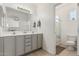 Bright bathroom with double sinks, a large mirror, and a separate toilet and shower area at 3037 E Hobart St, Gilbert, AZ 85296
