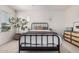Bright bedroom features a wrought iron bed frame, neutral colors, and a large window at 3037 E Hobart St, Gilbert, AZ 85296
