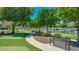 Outdoor common area of the neighborhood featuring putting green, bench and sidewalks at 3037 E Hobart St, Gilbert, AZ 85296