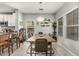 Bright dining room featuring a wooden table, stylish wicker chairs, and decorative wall plants at 3037 E Hobart St, Gilbert, AZ 85296
