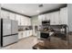Bright kitchen features stainless steel appliances and white cabinets at 3037 E Hobart St, Gilbert, AZ 85296