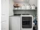 Well-organized laundry room with modern washer and dryer, shelving, and storage baskets at 3037 E Hobart St, Gilbert, AZ 85296