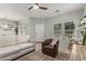 Bright living room features neutral colors, ceiling fan, and tile flooring at 3037 E Hobart St, Gilbert, AZ 85296