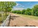 Dirt path running parallel to a white fence, with lush green trees at 3037 E Hobart St, Gilbert, AZ 85296