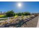 Expansive yard with fruit trees, green grass and white fence under a sunny sky at 3037 E Hobart St, Gilbert, AZ 85296