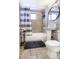 Compact bathroom features a shower/tub combo, a pedestal sink, and neutral tiling for a clean, functional space at 310 W Earll Dr # 102, Phoenix, AZ 85013