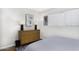 Bedroom with natural light, a wooden dresser, and a striped bed, creating a simple yet cozy space at 310 W Earll Dr # 102, Phoenix, AZ 85013