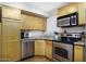 Functional kitchen features stainless steel appliances, sleek countertops, and plentiful cabinet space at 310 W Earll Dr # 102, Phoenix, AZ 85013
