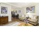 Spacious living room with hardwood floors, comfortable seating, and an adjacent dining area at 310 W Earll Dr # 102, Phoenix, AZ 85013