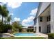 Lush backyard featuring a sparkling pool, manicured landscaping, and a covered patio at 3133 E Silo Dr, Gilbert, AZ 85296