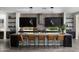 Modern kitchen features dark cabinets, stainless steel appliances, granite countertops and seating for five at 3133 E Silo Dr, Gilbert, AZ 85296