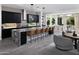 Modern kitchen features dark cabinets, stainless steel appliances, granite countertops, and seating for six at 3133 E Silo Dr, Gilbert, AZ 85296