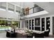 Open-concept living room with high ceilings, modern light fixtures, and poolside views at 3133 E Silo Dr, Gilbert, AZ 85296