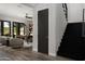 Comfortable living room with desk, black stairs, and backyard views through French doors at 3133 E Silo Dr, Gilbert, AZ 85296