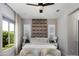 Bright main bedroom featuring a decorative headboard, soft natural light, and a ceiling fan at 3133 E Silo Dr, Gilbert, AZ 85296
