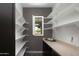 Pantry features white shelving, dark cabinets, countertop and a small window overlooking the property at 3133 E Silo Dr, Gilbert, AZ 85296