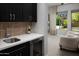Convenient wet bar with a stainless steel sink, wine fridge, and views of the backyard at 3133 E Silo Dr, Gilbert, AZ 85296