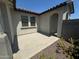 An outdoor patio offers a relaxing space with stone landscaping, complemented by the stucco home exterior at 3375 W Verde River Rd, San Tan Valley, AZ 85144