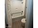 Clean bathroom featuring a bathtub with a shower, a modern toilet, and neutral color scheme at 3375 W Verde River Rd, San Tan Valley, AZ 85144