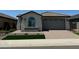 Charming single-story home with a tile roof, manicured lawn, and a brick-paved driveway leading to a two-car garage at 3375 W Verde River Rd, San Tan Valley, AZ 85144