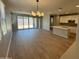 Bright and open-concept living room with sleek hardwood floors and a sliding glass door to the backyard at 3375 W Verde River Rd, San Tan Valley, AZ 85144