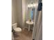 Compact powder room featuring a pedestal sink, modern faucet, and a toilet with sleek design at 3375 W Verde River Rd, San Tan Valley, AZ 85144