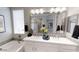 Bright bathroom featuring a double vanity with a white countertop, stylish fixtures, and framed mirrors at 35068 N Sacramento Wash Rd, San Tan Valley, AZ 85144