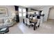 Cozy dining area with a modern table set, next to the living room and open kitchen at 35068 N Sacramento Wash Rd, San Tan Valley, AZ 85144