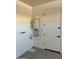 Functional utility area showing the tankless water heater and door at 35068 N Sacramento Wash Rd, San Tan Valley, AZ 85144