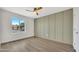 Cozy bedroom featuring a modern green accent wall, ceiling fan and a large window at 3614 W Danbury Dr, Glendale, AZ 85308